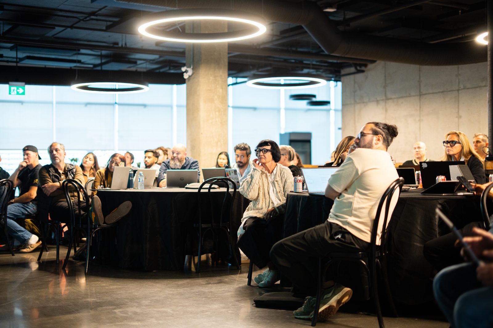 A full room at one of Nav's live Claude sessions, laptops open